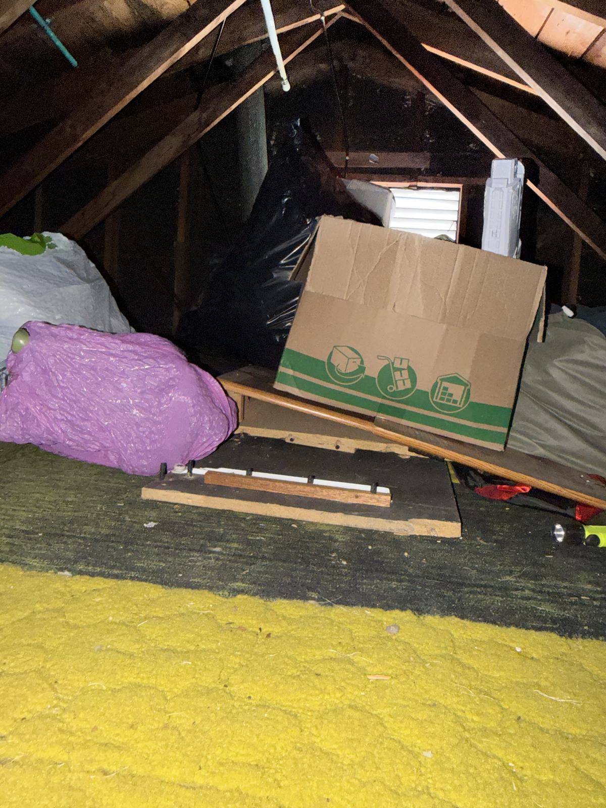 Attic packed with bags and cartons before MD Junk Pros cleanout in Central Maryland