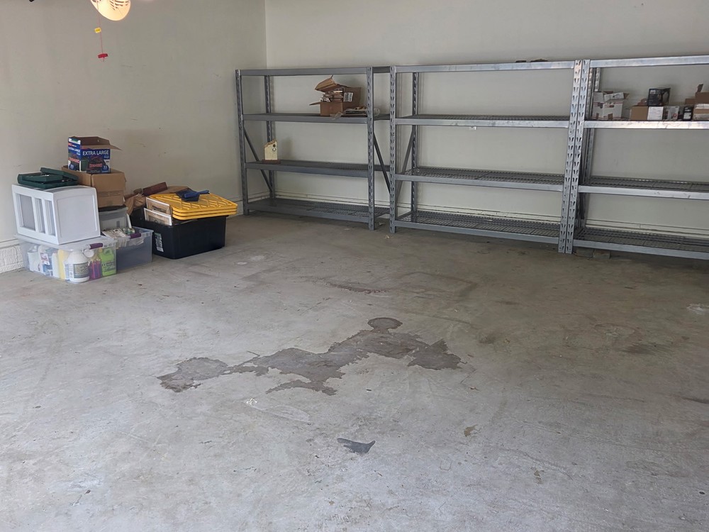 Cleared two-car garage with a swept slab after the cleanout on Dawn Whistle Way in Bowie, MD