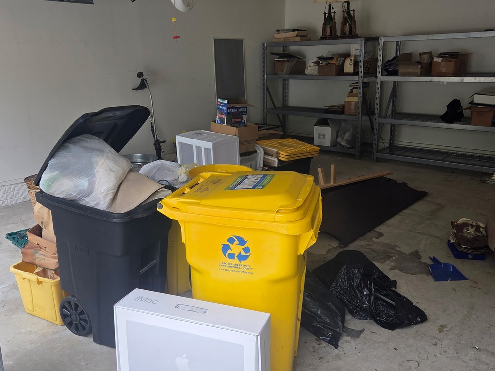 Two-car garage packed with totes, boxes and bins before a garage cleanout on the Woodmore side of Bowie, MD