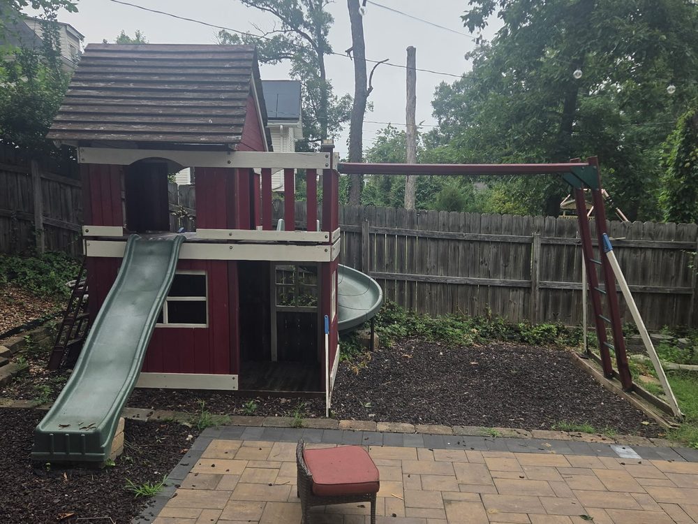 Large wooden playhouse, slide and swing set before removal in the Fairwood community of Bowie, MD