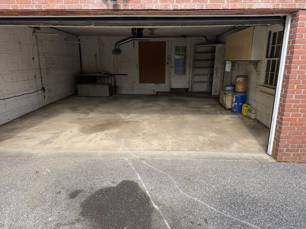 Swept two-car garage cleared to bare concrete after a garage cleanout in Catonsville, MD