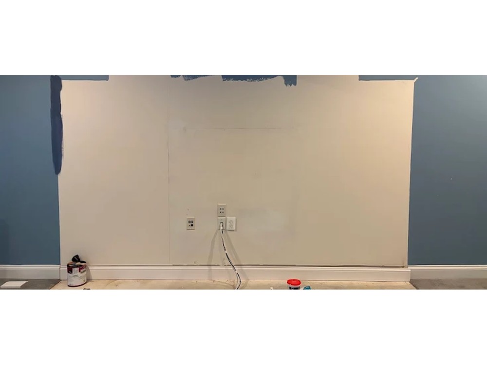 Bare drywall wall with the built-in removed and patched flat after an entertainment center demo in Clarksville, MD