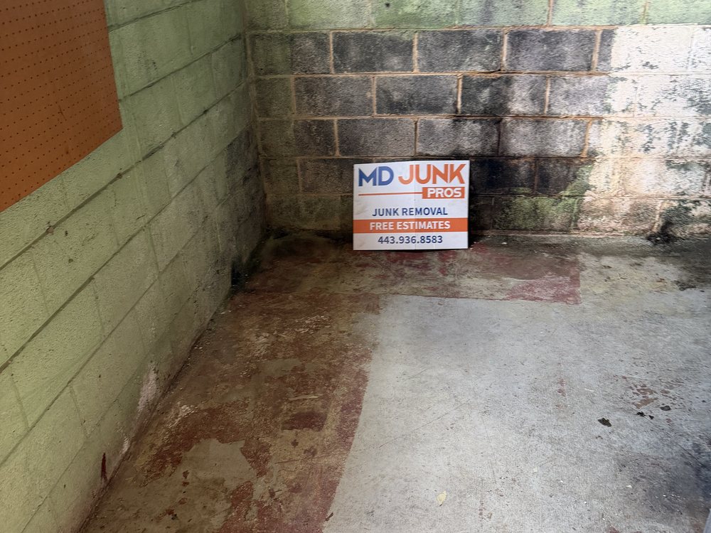 Same basement corner cleared to bare block and floor after the cleanout on Carlinda Avenue in Columbia, MD