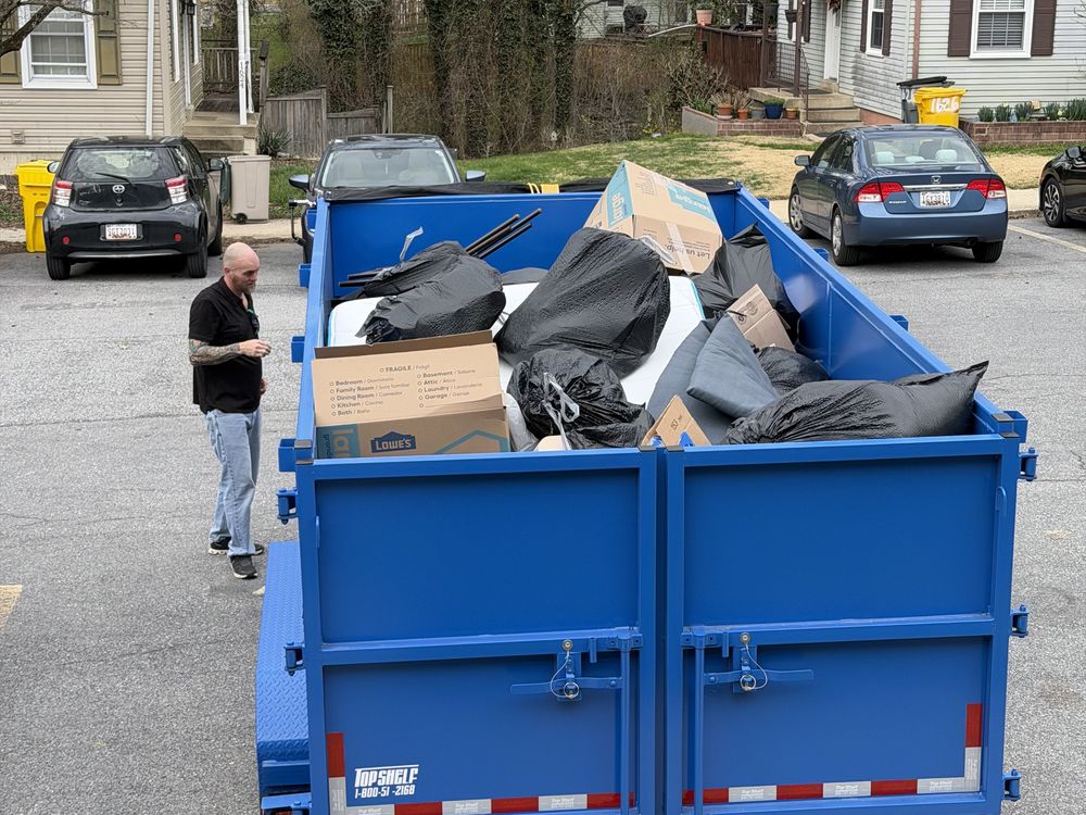 Second loaded dump trailer with a mattress, bagged debris and boxes from a Mount Airy Court townhouse cleanout in Crofton, MD