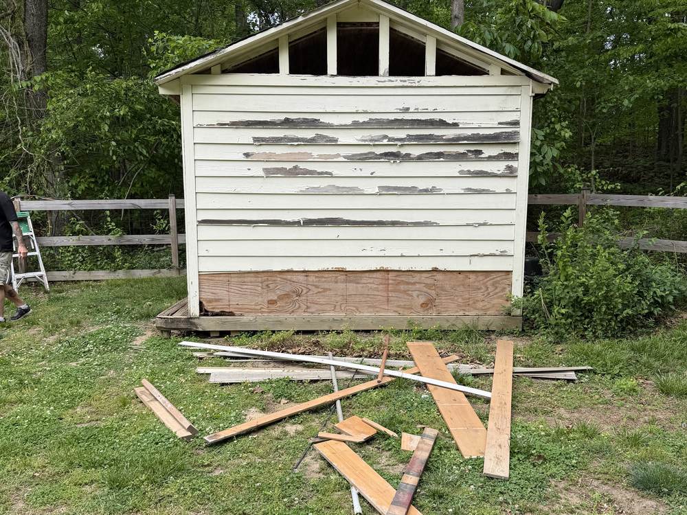 Shed with roof shingles and sheathing stripped during teardown in Davidsonville, MD
