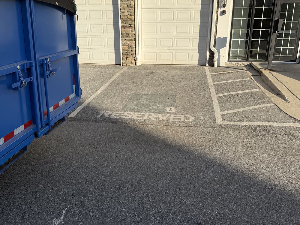 Same reserved parking space cleared with the MD Junk Pros trailer after the turnover on Greenfield Road in Elkridge, MD