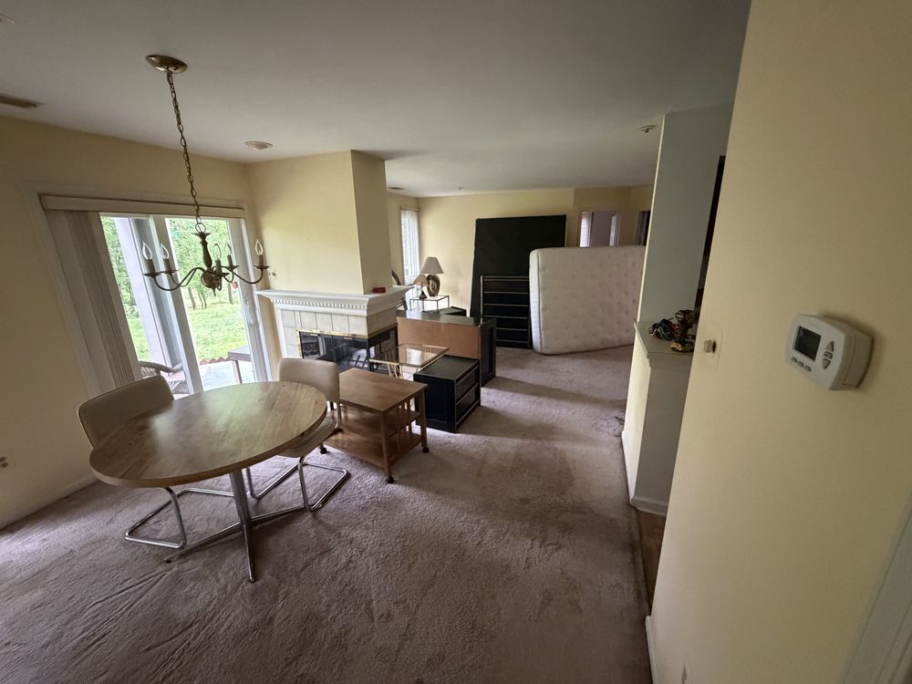 Condo living and dining area still furnished before a pre-listing furniture removal in Ellicott City, MD