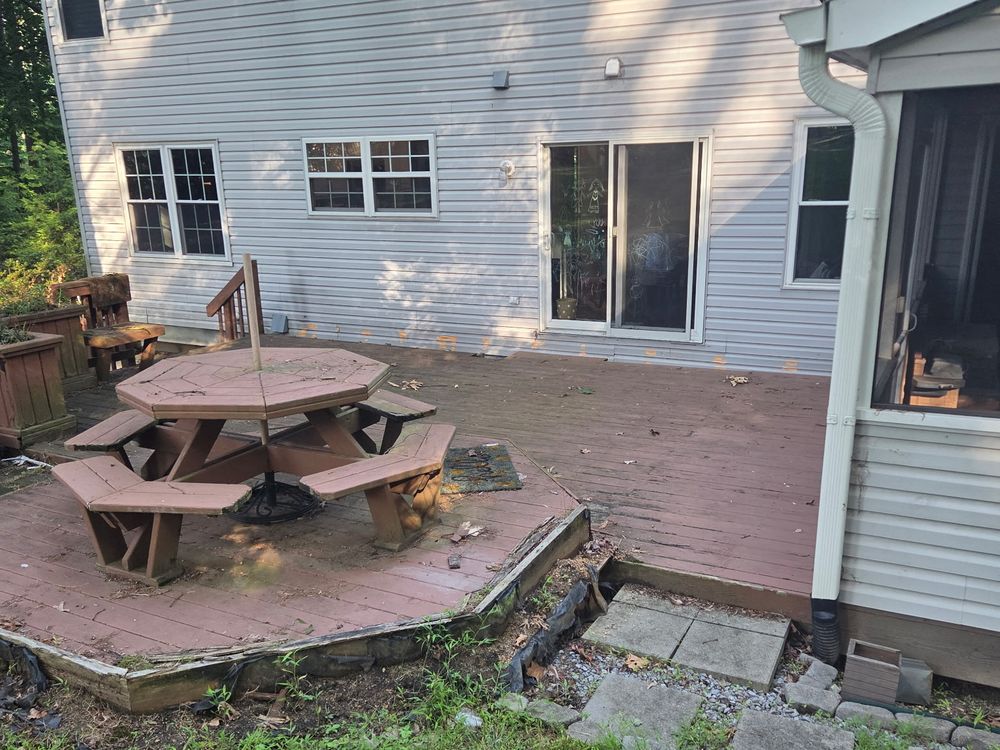 Aging backyard deck with a picnic table before full demolition in Ellicott City, MD