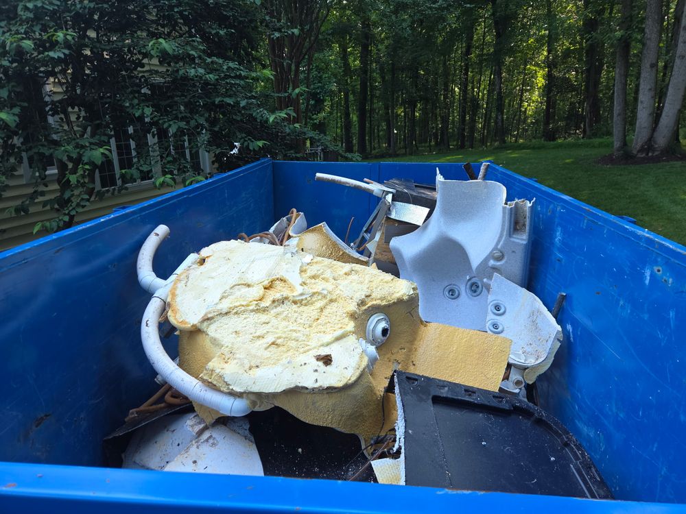 Hot tub shell cut into sections and loaded into a dump trailer in Ellicott City, MD