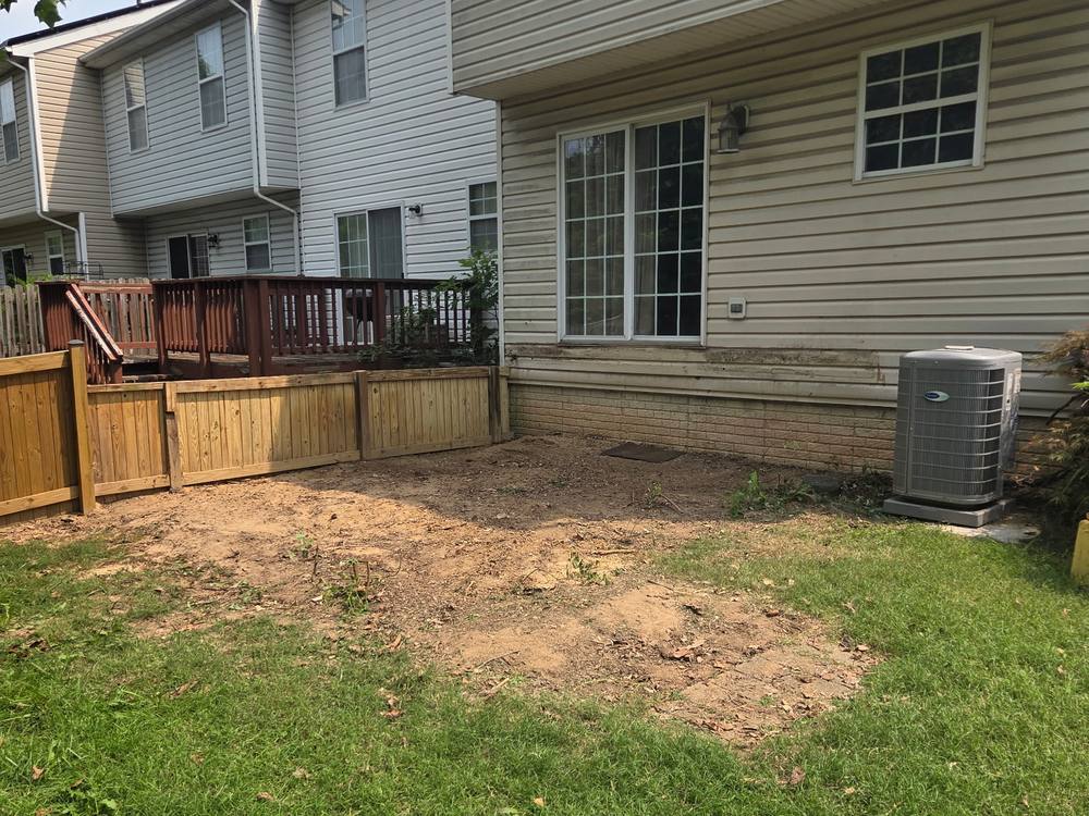 Backyard cleared to bare dirt where an old deck was demolished and hauled away in Ferndale, MD