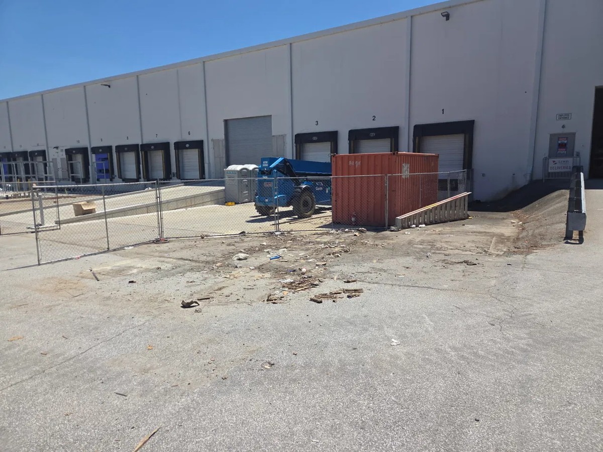 Cleared loading dock area at a Gambrills business park off Benfield Boulevard after MD Junk Pros removed the pallets and construction debris
