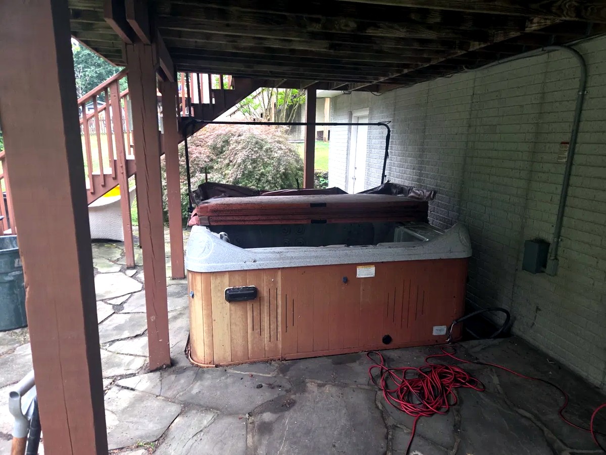 Old hot tub under a backyard deck at a Gambrills home off Sinclair Lane before demolition and removal