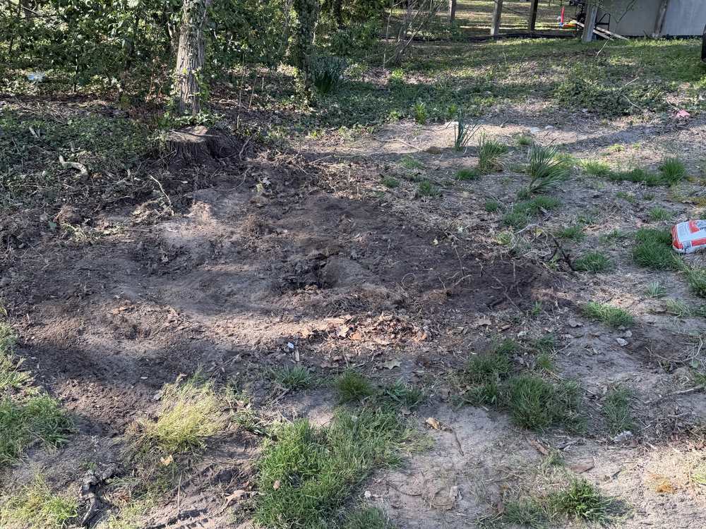 Cleared bare ground where the shed stood after the shed demolition and haul-away in Glen Burnie, MD