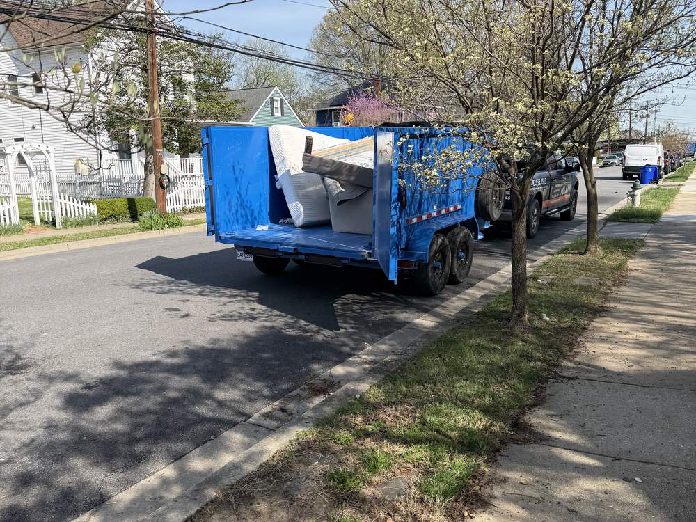 Same curb cleared with the loaded MD Junk Pros trailer hauling it away on Laurel Avenue in Laurel, MD