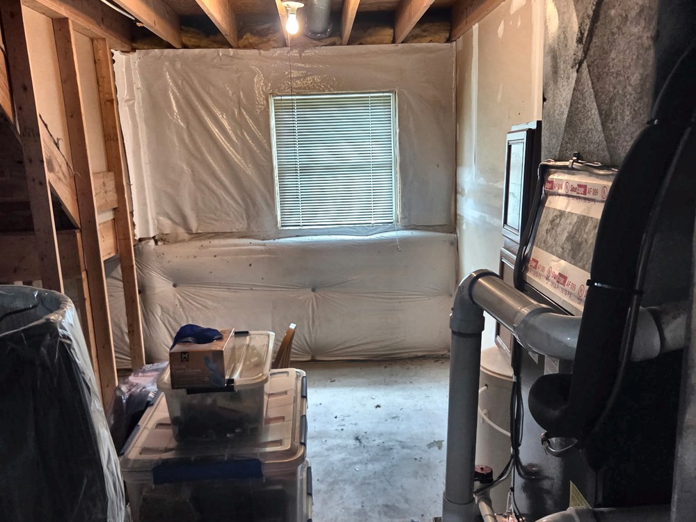 Cleared basement with an open concrete floor by the furnace after an estate basement cleanout in Millersville, MD