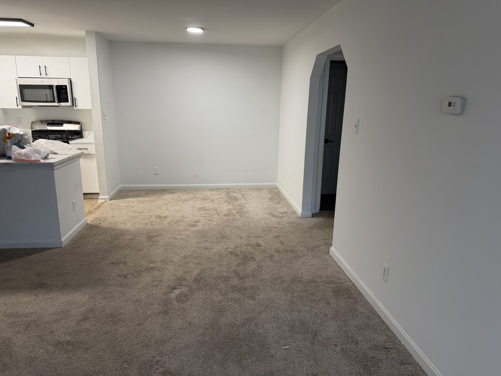 Same apartment living room emptied and broom-clean after the move-out cleanout off Peaceful Way in Odenton, MD