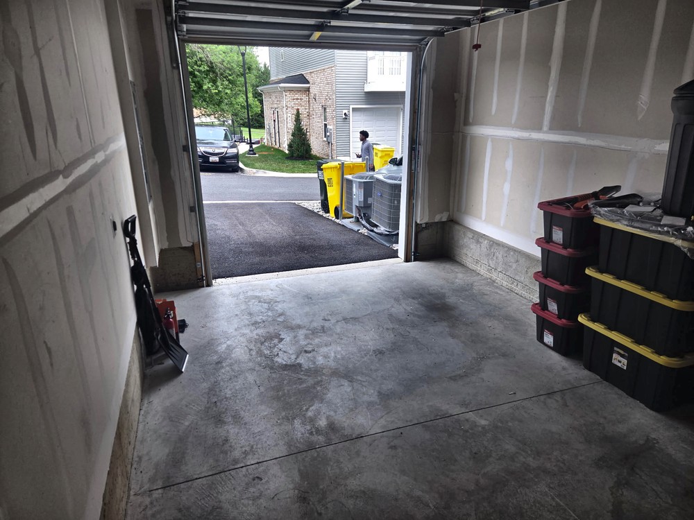 Cleared two-car garage with a swept floor after the cleanout on Yellow Sand Lane in Odenton, MD
