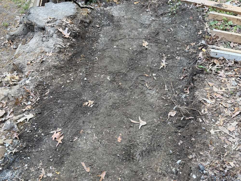 Bare graded ground after a concrete pad was broken out and hauled in Pasadena, MD