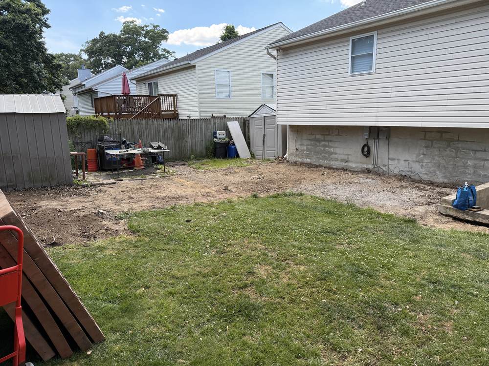 Cleared and raked ground where a deck stood after demolition in Pasadena, MD